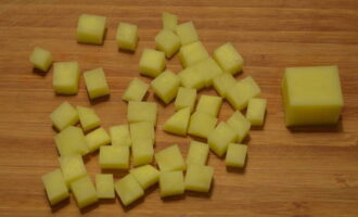 Cut the potatoes into large cubes the size of the beans. Add to meat broth.