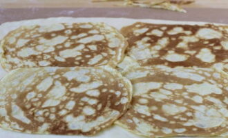 Roll out the dough on a work surface and place pancakes on top.