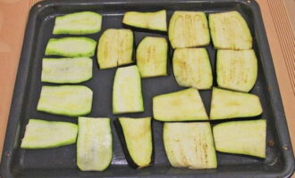 Place the zucchini and eggplant on a greased baking sheet. Bake the product for 10 minutes at 200 degrees.