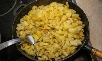 Salt the potatoes and fry until half cooked.