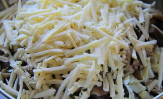 Grind the hard cheese on a coarse grater directly over the salad bowl.