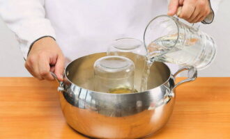 Wash the jars in which the tomatoes will be fermented well under running water and pour boiling water over them. At the bottom we put an umbrella of dill, garlic and part of the celery.