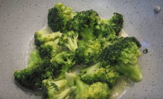 Doe de gedroogde broccoliroosjes in hete olie en bak ze aan beide kanten op middelhoog vuur.Bepaal de mate van braden volgens uw smaak. Broccoli in een koekenpan is klaar. Verdeel het over borden en serveer met een stukje vis en rijst.