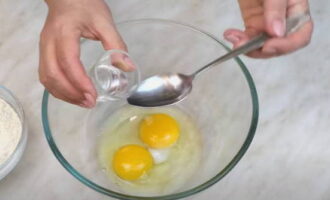 How to cook noodles at home? Break the eggs into a bowl. Add salt and water, shake with a fork. Add flour in portions and gradually knead into a thick, elastic dough. 