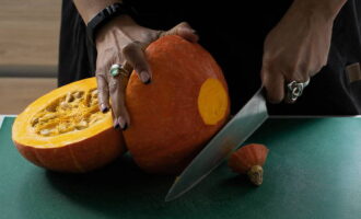 Choose a pumpkin with dense orange flesh and cut off its tops evenly. Cut the pumpkin itself in half. 