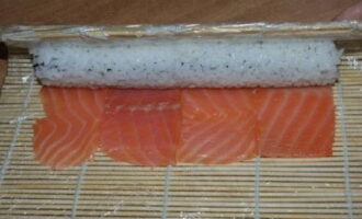 Carefully wrap the roll in a layer of fish.