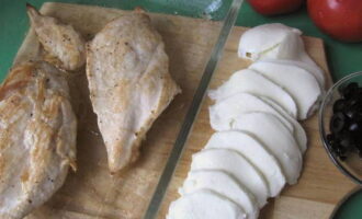 Season the chicken fillet with salt and pepper, cover with film and lightly pound. Fry whole in heated oil until golden brown, and then bring to readiness in the oven for 10 minutes, turning it on at 200 degrees. Then cool and cut into small pieces. 