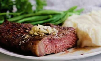 Cut the steak into portions and serve with a side dish of your choice.