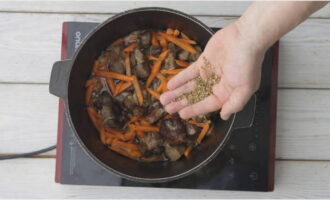 Next, place the chopped carrots into the cauldron and fry them for 3 minutes without stirring. After three minutes, mix all the ingredients with a spatula and cook the zirvak for another 10 minutes. Grind the coriander and cumin in your palms or in a mortar and pour this mixture into a cauldron. Add dried barberries and salt to your taste. 