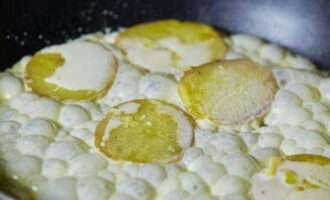 In a separate frying pan, fry the potato slices until golden brown.