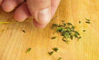 Remove the leaves from the thyme sprigs.