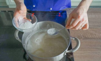 Pour water into a deep saucepan, put it on the fire and bring to a boil. Then add the split peas, bring to a boil again and add the chopped potatoes.