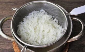 Boil the rice noodles until tender and discard in a colander.