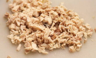 Cut the chilled chicken into cubes or disassemble it into fibers.