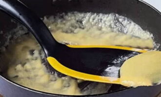 Gradually add flour to the butter and bring to a slightly golden brown color with constant stirring.