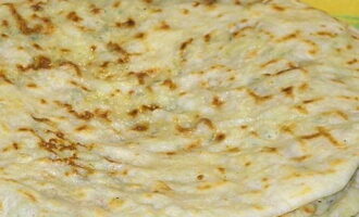 Grease the hot flatbreads with butter, stack them, cut them into four pieces and serve with ayran, kefir, sour cream or tomato juice. Bon appetit!