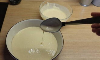 Pour half of the dough into the baking dish.