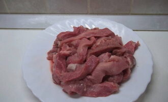 How to cook beef goulash with gravy in a slow cooker? Wash the beef tenderloin under running water, pat dry with paper towels and cut into small pieces. Turn on the multicooker, select the Baking mode, pour vegetable oil into the bowl and fry the beef for 20 minutes, stirring occasionally.