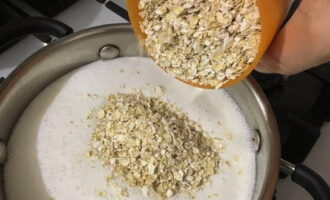 When the milk boils, add the cereal into the pan.