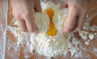 Then put three yolks into this mixture and mix everything with your hands.