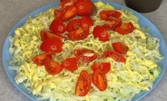 In a separate bowl, whisk together the dressing ingredients listed in the recipe. Remove thickened bases from Chinese cabbage and chop the leaves into strips. Place them on a salad serving plate. Apply a mesh of prepared dressing onto the cabbage through a pastry bag. Place cherry tomatoes cut into quarters on top of it.