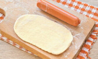 Dust the cutting board with flour. Roll out the pieces with a rolling pin into thin flat cakes as long as sausages.