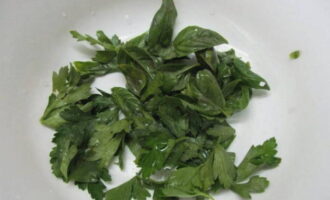 Place washed and dried basil and parsley leaves in a salad bowl.