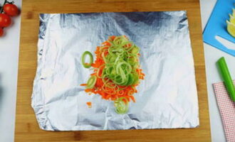 Place a sheet of foil folded in half on your work surface. First add the vegetables.