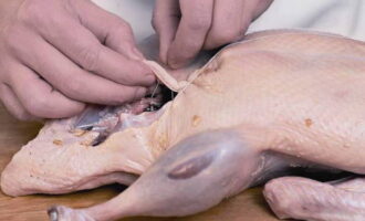 Stuff the duck with some of the filling, sew up the belly with thread, it should not be very tightly stuffed. Place the remaining filling in a baking dish.