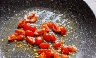 Place the frying pan over moderate heat and melt the butter, then add the chopped tomatoes and simmer for several minutes.