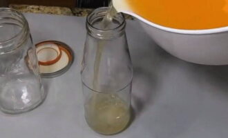 Filter the prepared vinegar through cheesecloth several times and pour into clean bottles. Seal the bottles hermetically and store them in a basement or pantry. You can use this apple cider vinegar in your cooking throughout the year.