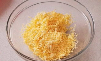 In another bowl, combine grated hard cheese and garlic, passed through a press.