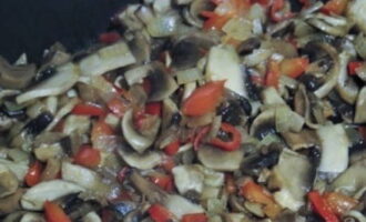 Simmer the peppers, mushrooms and onions over low heat until excess moisture evaporates.