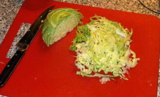 Chop the cabbage into thin strips.