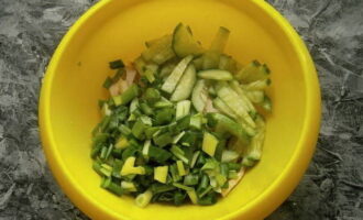 Now add fresh cucumber cut into strips or cubes and chopped green onions to the chicken.