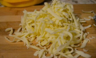 Grate any hard cheese with large holes.