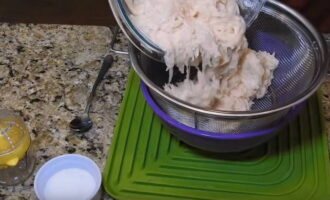 Place the grated potatoes in a colander to drain some of the liquid.