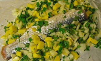 Place potatoes with spices around the fish.