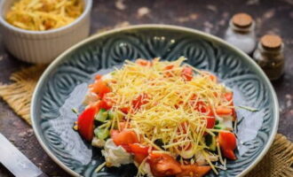 Grind a piece of hard cheese using a grater with small holes and sprinkle on the vegetables.