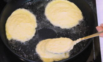 Heat the vegetable oil in a thick-bottomed frying pan and add the potato mixture with a tablespoon, forming pancakes.