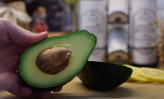 The avocado is washed and cut in half with a sharp knife. Then the bone is carefully separated.