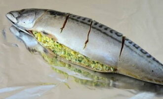 Place the gutted mackerel on a sheet of foil and stuff it with the cheese and egg mixture. 