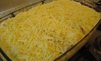 After 30 minutes, remove the pan from the oven and sprinkle the dish with grated hard cheese. Continue baking for another 15 minutes.