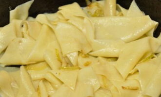 Place the finished diamonds in a colander and give a little time for excess liquid to drain. Afterwards, transfer the noodles to the sautéed onions and mix thoroughly.