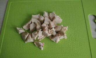 We separate the chicken by hand into fibers or cut it into cubes