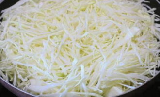 Cabbage is shredded into thin straw using a sharp knife or kitchen gadgets. The cabbage slices are transferred to a saucepan or deep frying pan.