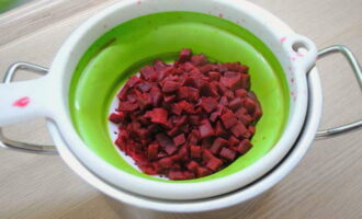 Drain most of the beet broth through a colander and into another pan.