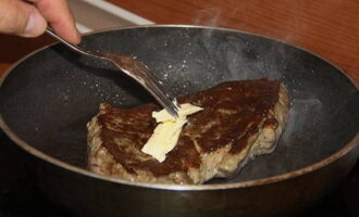 Place pieces of butter on top of the meat.