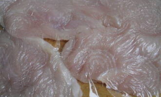 Attraverso la pellicola trasparente, per non danneggiare le fibre della carne, sbattere leggermente il filetto con un martello su entrambi i lati.