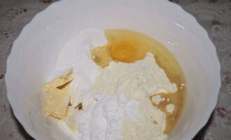 In a deep bowl, combine all the ingredients: flour, two types of butter, egg, starch, powdered sugar, salt, vanillin and baking powder.